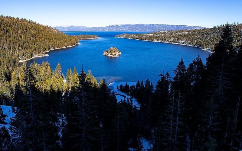 Snow-covered Lake Tahoe shoreline and turquoise water photographed by Neal Nachman