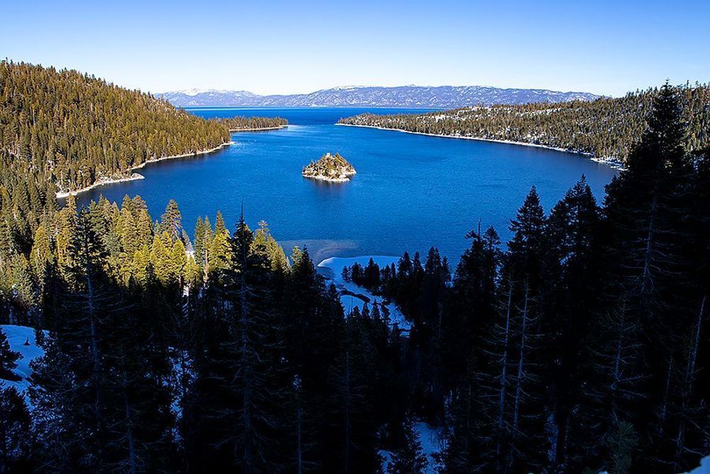 Emerald Bay at Lake Tahoe, with a small island surrounded by blue water and snow-dusted forest